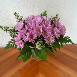 Pink daisy bouquet in a clear glass vase