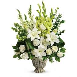 White and green floral arrangement in a decorative urn vase