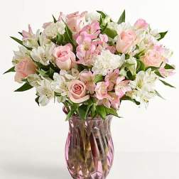 Pink and white mixed bouquet in a pink glass vase