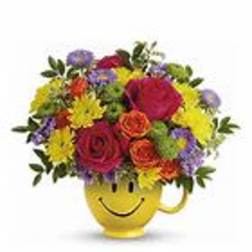 Colorful mixed bouquet in a yellow smiley-face mug