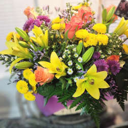 Mixed bouquet with yellow lilies, peach roses, and purple mums