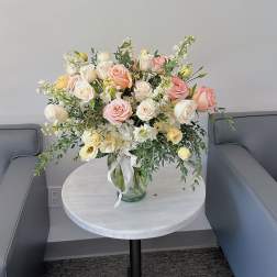 Bouquet of blush and white roses in a glass vase