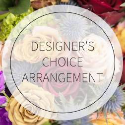 Designer’s choice floral arrangement with roses and thistle-like blooms