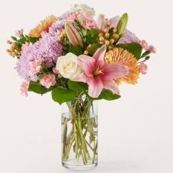 Pink and peach mixed bouquet in a clear glass vase