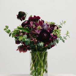 Dark burgundy bouquet in a clear glass vase