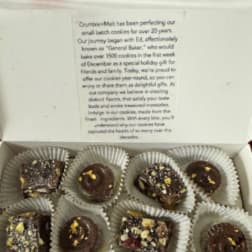 Box of assorted chocolate cookies in paper cups