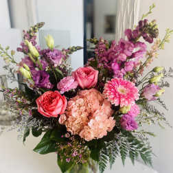 Mixed pink and purple bouquet in a clear glass vase