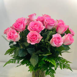 Pink roses arranged in a clear glass vase