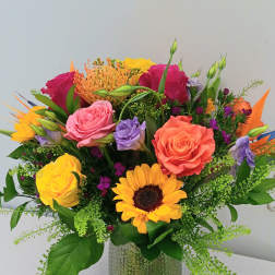 Colorful mixed bouquet in a textured glass vase