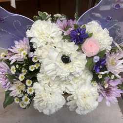 White and lavender floral arrangement with purple butterfly wings