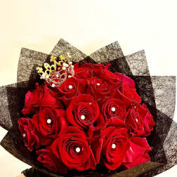 Bouquet of red roses with a small gold crown topper
