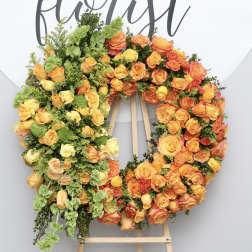 Large orange and yellow rose wreath on an easel