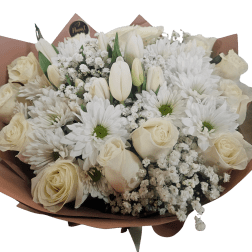 White roses and daisies with tulips in a wrapped bouquet