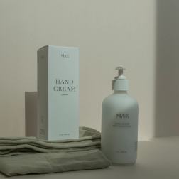 Hand cream bottle and box on folded cloth