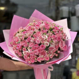Large bouquet of pink roses wrapped in pink paper