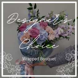 Wrapped bouquet of pastel roses and hydrangeas with lavender flowers