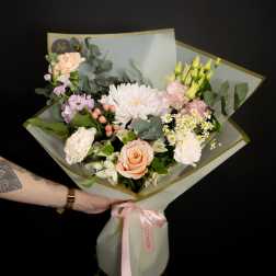 Hand-tied bouquet of peach and white flowers with pink ribbon
