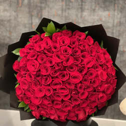 Large bouquet of red roses wrapped in black paper