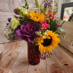 Colorful bouquet in a red vase with a birthday topper