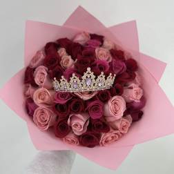 Bouquet of pink and burgundy roses with a jeweled crown topper