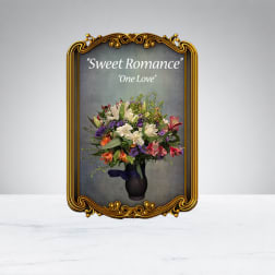 Mixed bouquet in a dark vase with an ornate gold frame