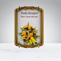 Yellow roses and daisies arranged in a decorative frame.