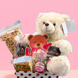 Teddy bear gift basket with assorted candy and snacks