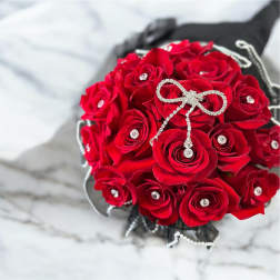 Red rose bouquet with rhinestone accents and a jeweled bow