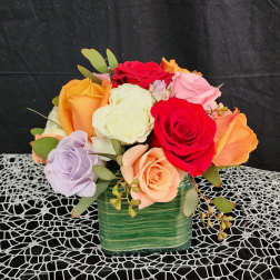 Colorful rose bouquet in a green square vase