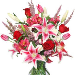 Bouquet of pink lilies and red roses in a glass vase