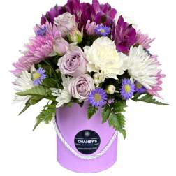 Lavender and white bouquet in a purple hatbox