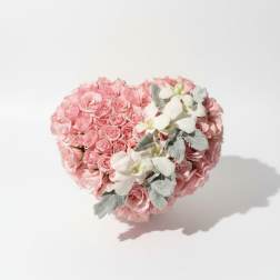 Heart-shaped bouquet of pink roses with white orchids