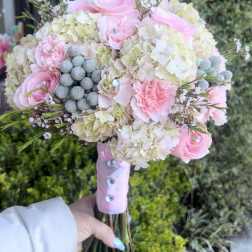 Pink roses and hydrangeas in a hand-tied bouquet
