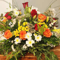Mixed bouquet of red and orange roses with white daisies and lilies