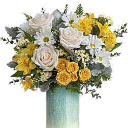 Bouquet of white and yellow flowers in a tall gradient vase