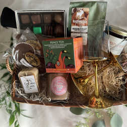 Gift basket with chocolates, tea, coffee, soap, honey, and two gold glasses