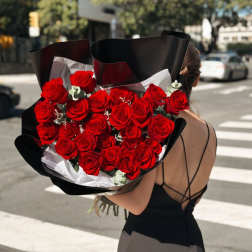 Large bouquet of red roses wrapped in black paper