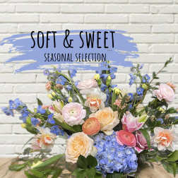 Mixed bouquet of pastel flowers with blue hydrangeas and pink roses