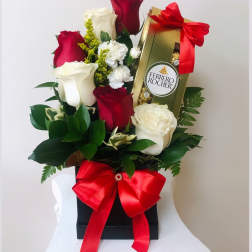 Red and white roses with a Ferrero Rocher box and red ribbon in a gift box