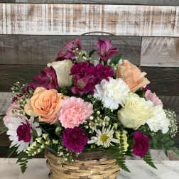 Mixed flower basket with roses, carnations, daisies, and alstroemeria