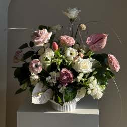 Pink and white floral arrangement in a white vase