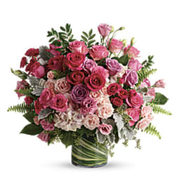 Pink and purple rose bouquet in a glass vase