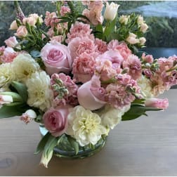 Pink and white floral arrangement in a glass vase