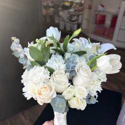 White bouquet with roses, lilies, carnations, and eucalyptus