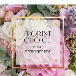Pastel pink and white mixed flowers with a label reading Florist Choice Vase Arrangement
