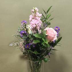 Pink and purple mixed bouquet in a clear glass vase