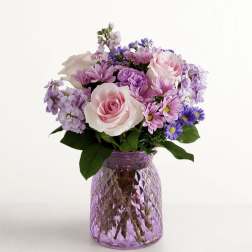 Pink and lavender mixed bouquet in a purple glass vase