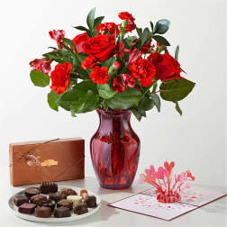 Red rose bouquet in a red vase with chocolates and a pop-up card