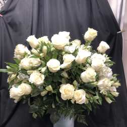 White rose arrangement in a silver pedestal vase