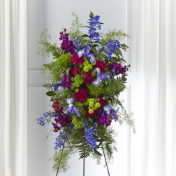 Tall standing floral spray with blue, purple, and green flowers